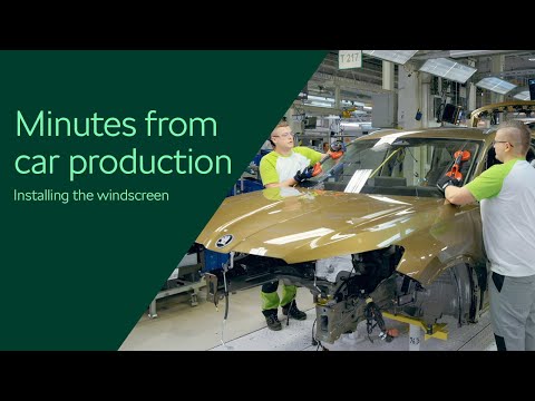 Minutes from car production: installing the windscreen