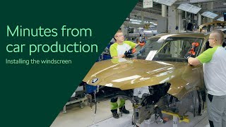 Minutes from car production: installing the windscreen