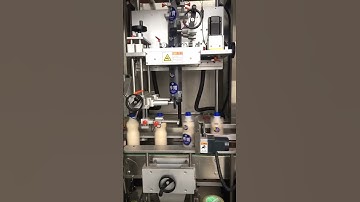 Automatic drink bottle shrink sleeve applicator