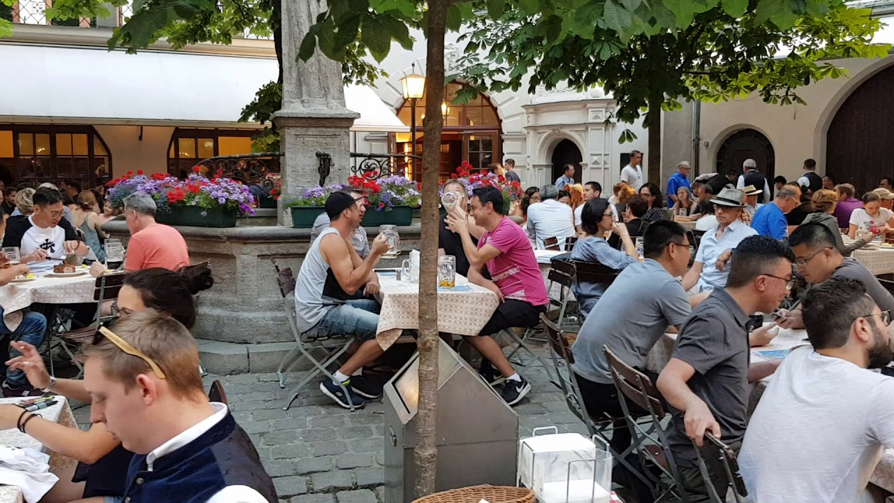 Beergarden in Munich. Biergarten. Cheers with a large beer in Munich