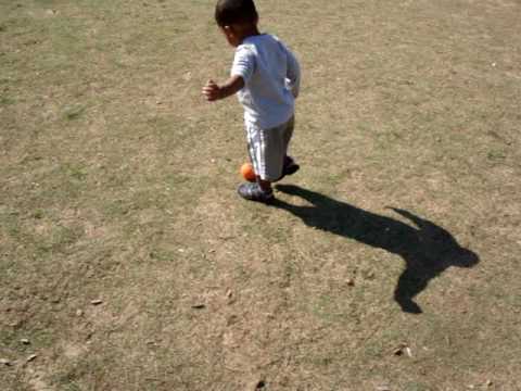 Mason practicing soccer kicks at Alexander Park with tennis ball