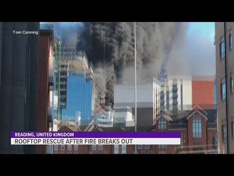 Crane operator in the UK rescues man from top of burning building - YouTube