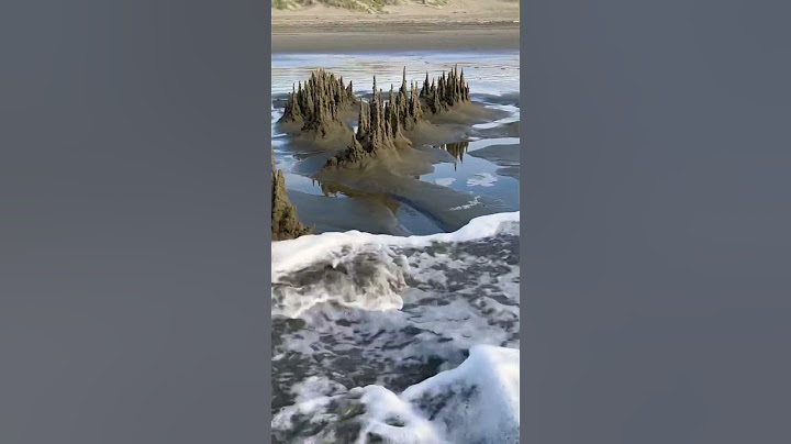 Sandcastle destroyed by a wave