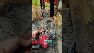 Construction workers vibrate wooden forms to compact concrete mix.#shorts #construction #shortvideo