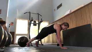 Plank with dumbbell pass through