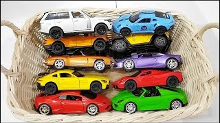 Box full of various miniature cars Toyota Vellfire, Land Rover Defender, Range Rover, Maybach