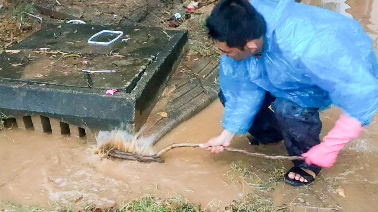 Unclogging Culvert Drain On Street Road After Heavy Rain - YouTube