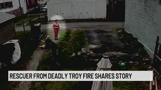 Woman in red identified after helping rescue man in Troy fire