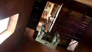 Using a winch to hoist a radio pack up inside an old fire hall tower