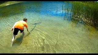 Skip to 1:59 to see the fish go after the bait. Turn the volume up because it is a little quiet. Materials used: stick, cattail, thorn, worm. 