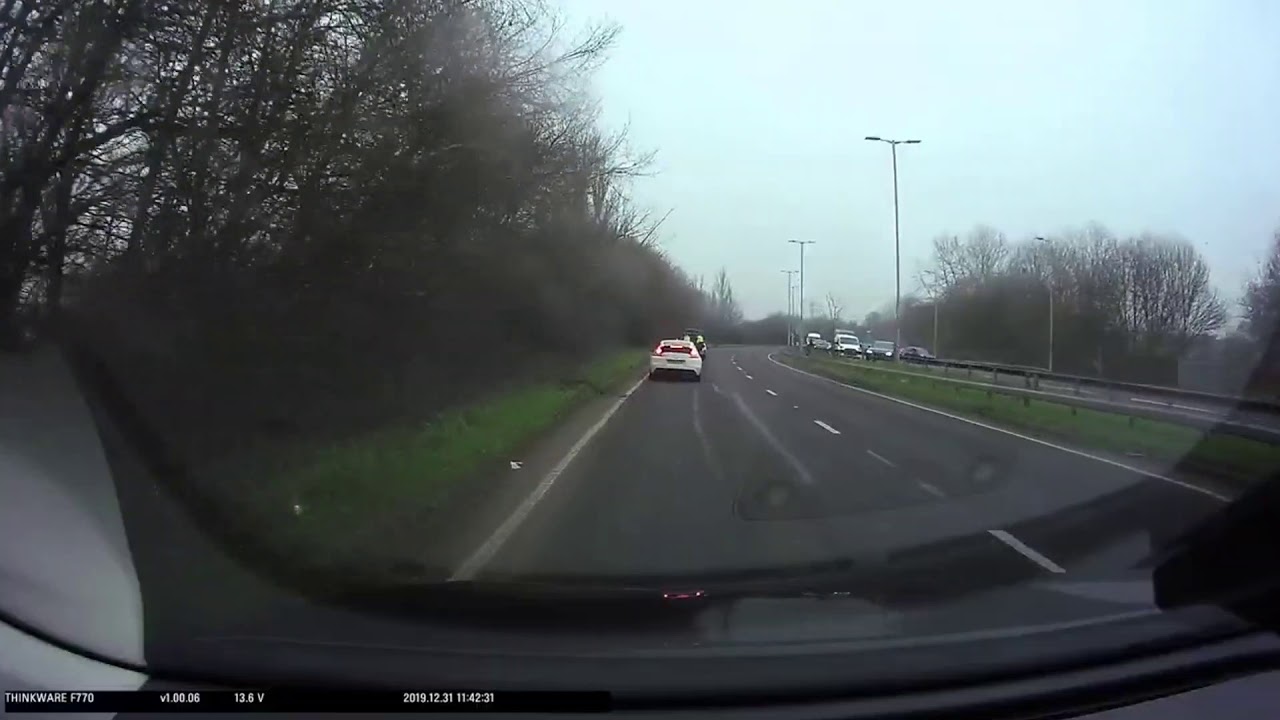 Police chase car going wrong way on roundabout before it bursts into ...