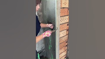 The Craftsman Scraping Putty On The Wall
