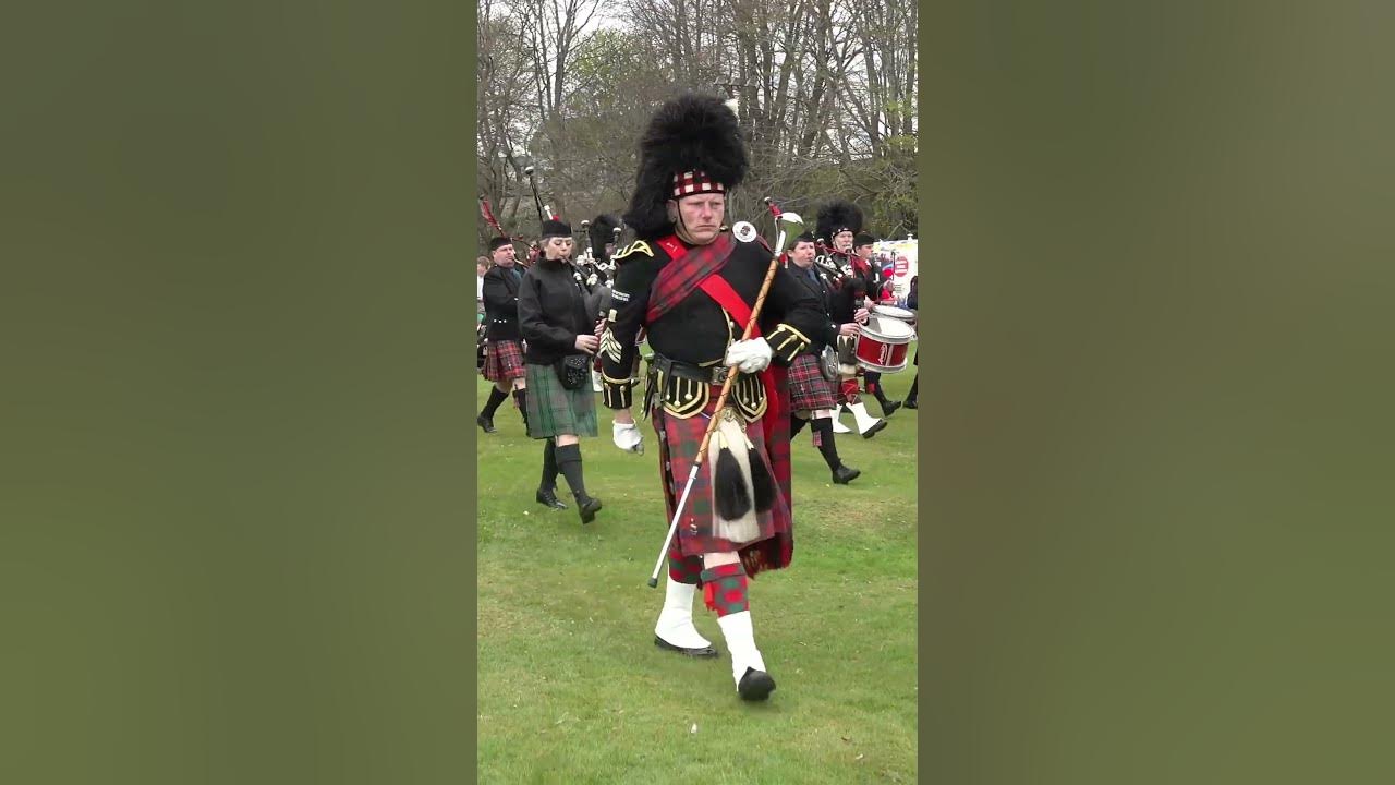 Drum Majors leading the Highland massed Pipes & Drums into Crawl Park