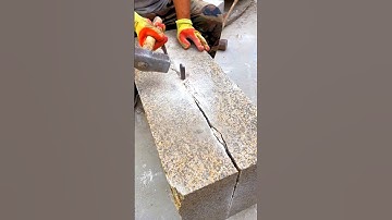 Split thick granite block using only a hammer and chisel, true skill for outdoor granite designs
