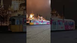 Hungarian Parliament Building in Budapest at Night with passing Tram.