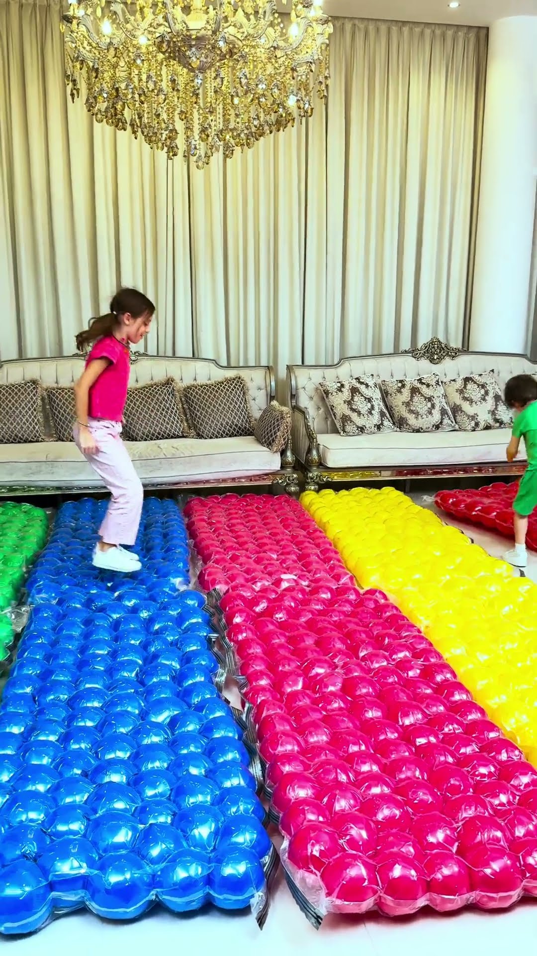Kids play on Mattresses made from Colorful Balloons