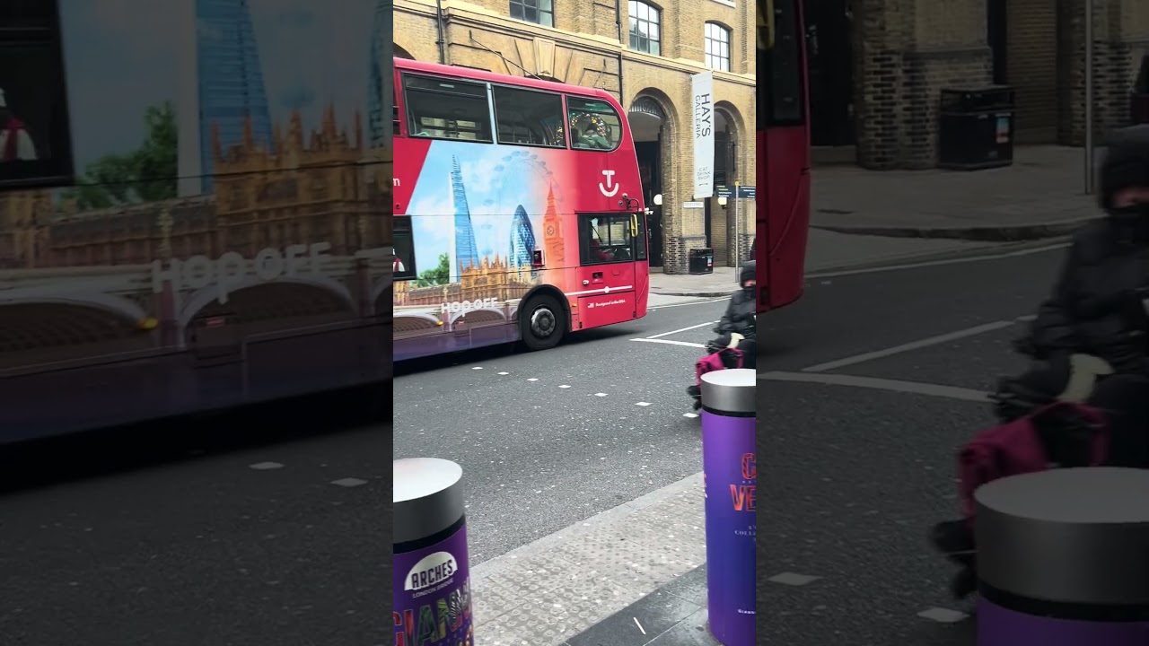 Topview Sightseeing open top Enviro 400 SN12EGY passes through Tooley Street on the Red Tour route