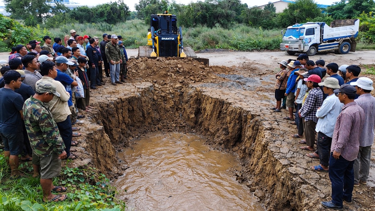 Nice bulldozer skill pushing soil to fill land with dump trucks