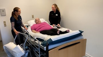 HoverSling Repositioning Sheet - Higher up in bed with two caregivers