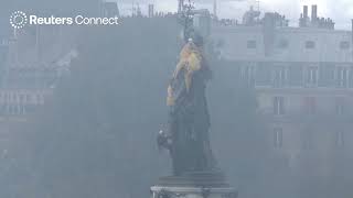 MOMENT: Protesters drape giant yellow vest over Paris statue