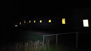 CSX Manifest train at night with DPU