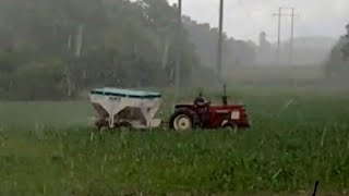 FARMER GETS SOAKED TOP DRESSING CORN IN THE RAIN