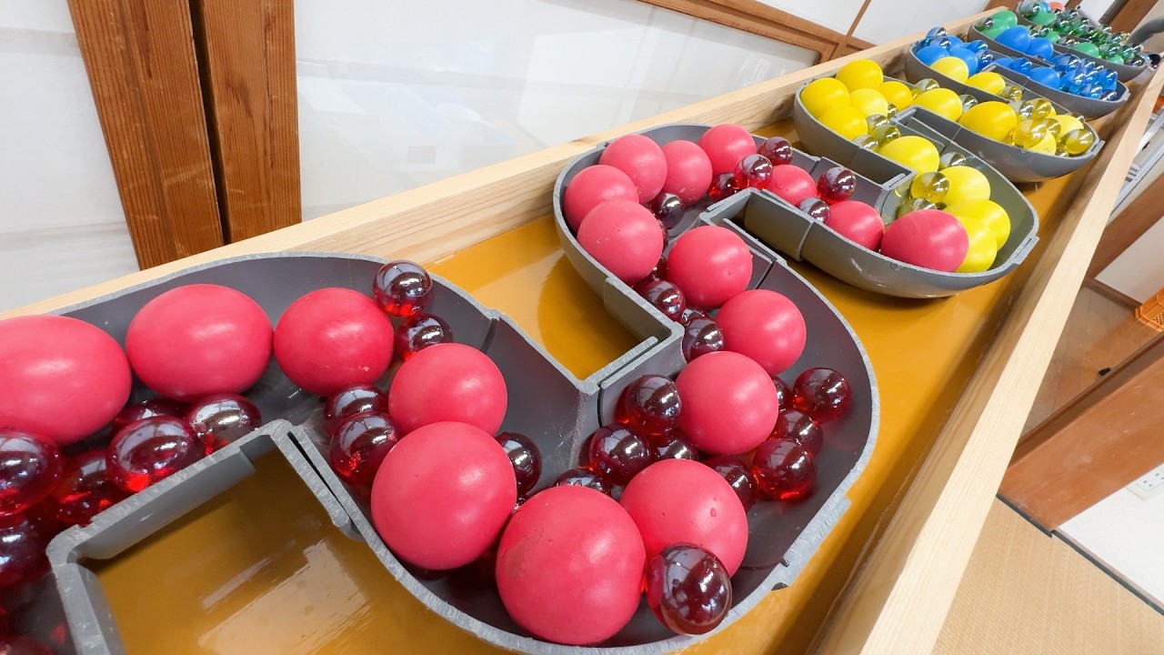 Marble run course using two pipe slopers, clear pipes, water, and large and small colored balls