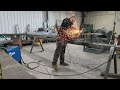 Welding up a sheet metal pipe taper.