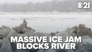 Ice jam threatens to flood river, people evacuate boats