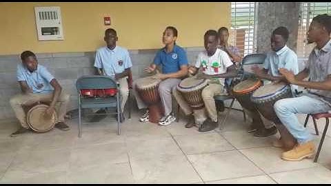 Dikembe Morton alongside the C.S.S and N.I.S.S drummers