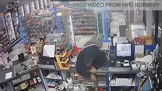Surveillance video: Clerk shot during robbery at convenience store