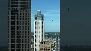 Slackliner Walks on a Slackline Connected between Two Towers