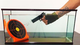 Gun shooting in the aquarium - Slow motion