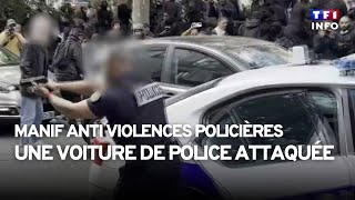 Une voiture de police attaquée par des manifestants à Paris