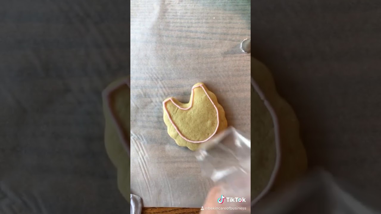 Baby bib sugar cookie decorated with buttercream