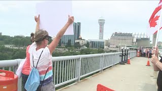 Group walks rainbow Bridge to border