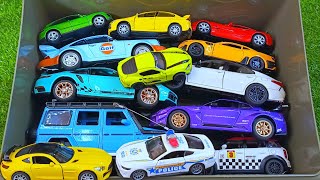 Box full of various miniature cars Peugeot, Volvo, Renault, Hyundai, Pagani, Cadillac One, DHL 104