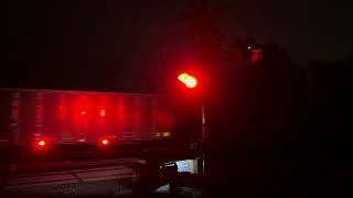 Northbound bnsf empty coal train at ice lake at night in the rain 