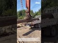 Loading Scrap Metal with An Electromagnetic Crane: Magnets Attracting Steel Pipes