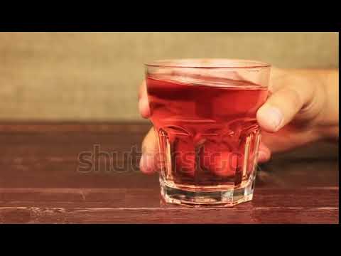 stock footage young man drinking raspberry juice roselle juice grape juice on wooden table