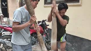 My traditional method of pounding a corn grain with a handcarved stone mortar and a wooden pestle
