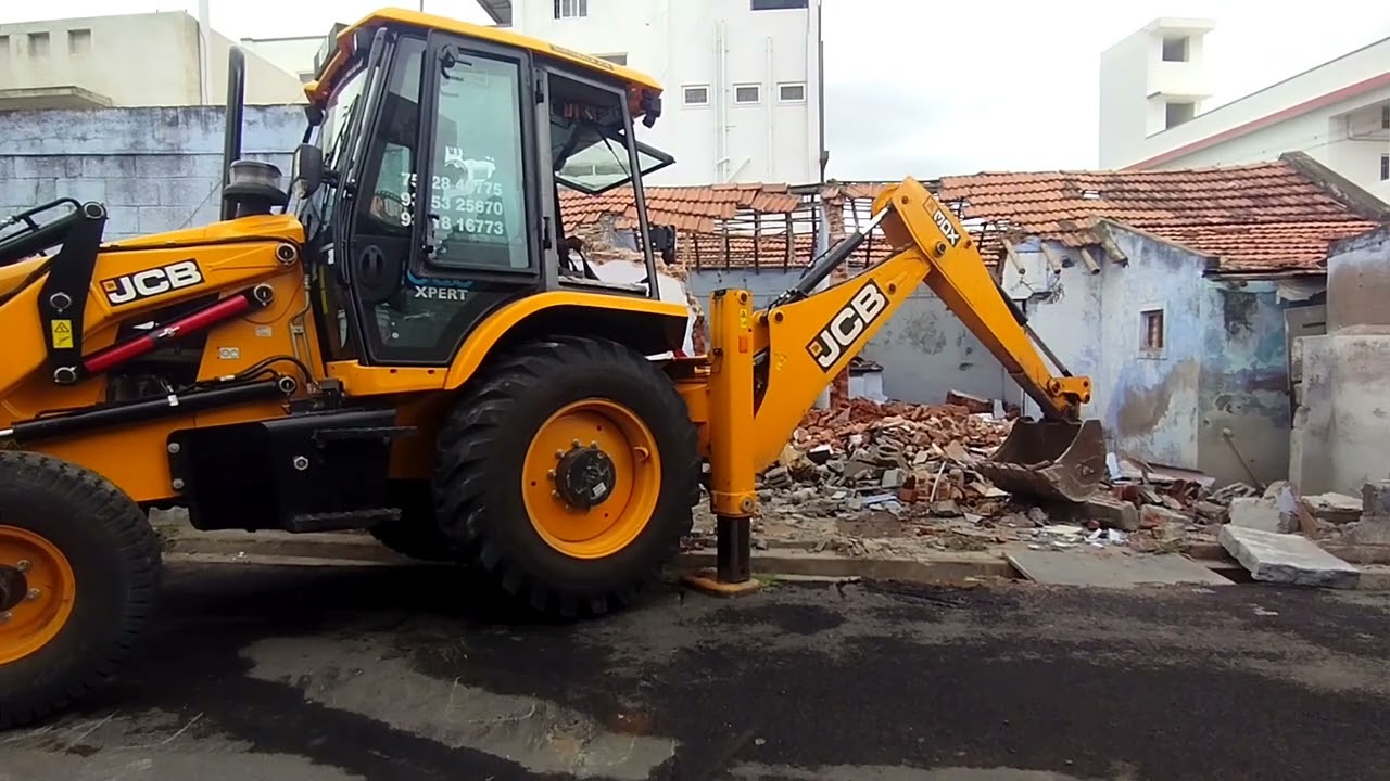 Old house Demolition work in Tiruppur. JCB 3DX demolishing the house.