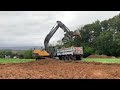 Volvo EC160 Excavator loading Mack Dump