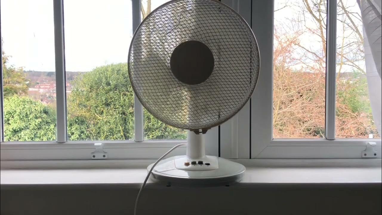The 2004 Homebase 12 inch desk fan running in a bright beautiful day