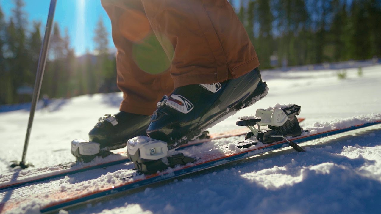 Downhill Skier Clipping Ski Boots into Ski Bindings in Slow Motion