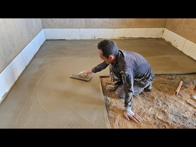 Cementing the floor of Sozan's dream house by the master worker class=