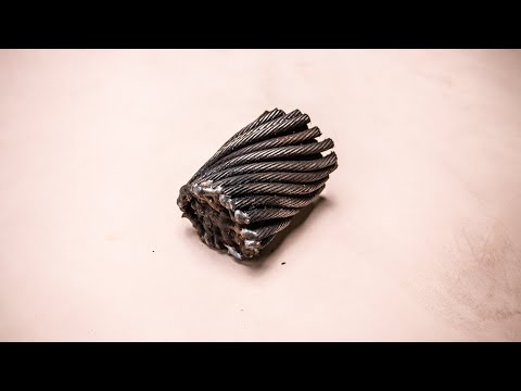 Forging a bottle opener from steel cable.