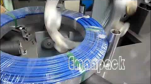 Horizontal coil wrapping machine packaging large rolls of hose and pipe