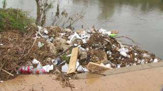 Piles of trash pollute San Antonio River near Mission Reach