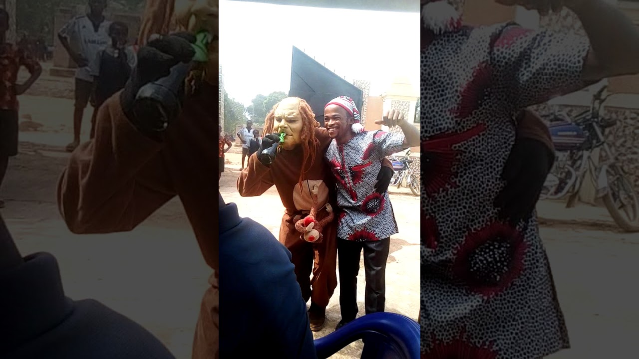 Masquerade drinks lager beer in a funeral in okija